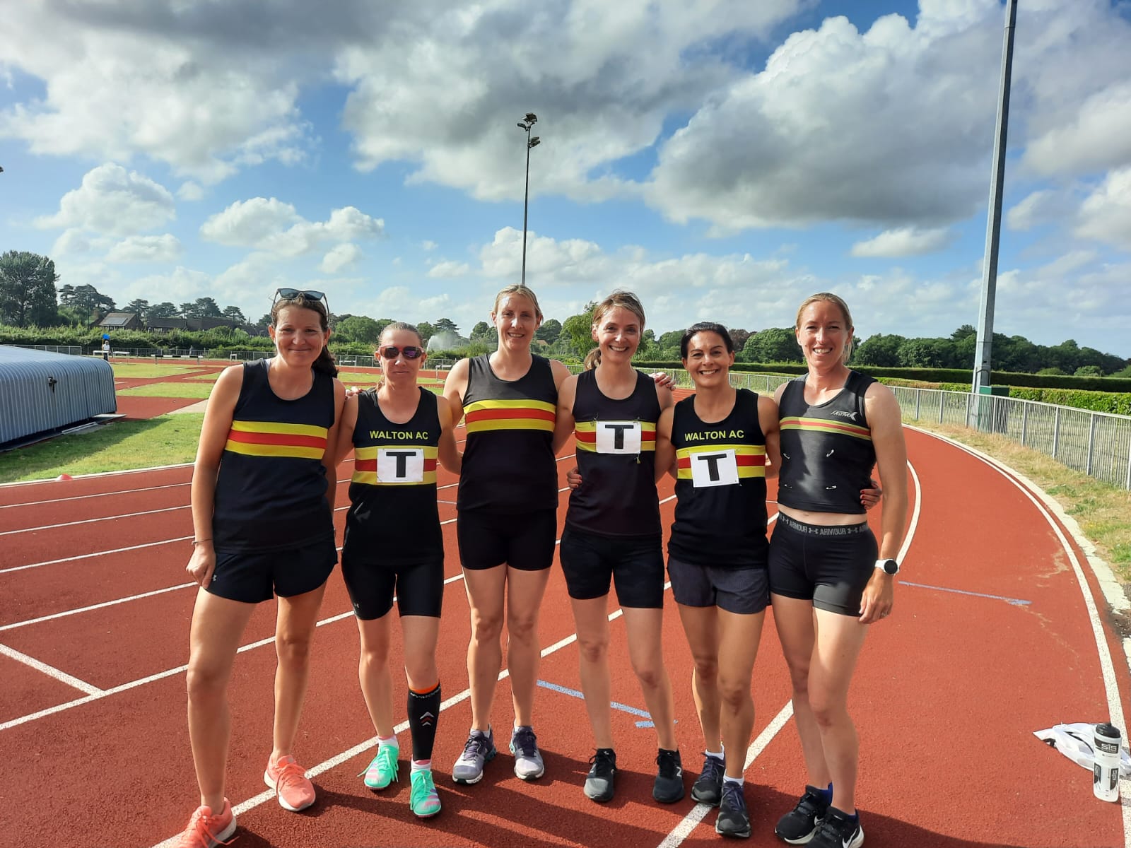 Five ladies on an athletics track