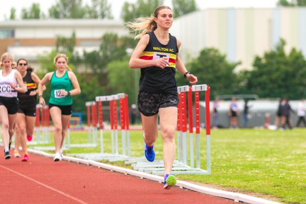 Lady running on an athletics track