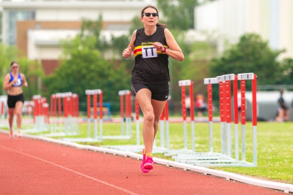 Lady running on an athletics track