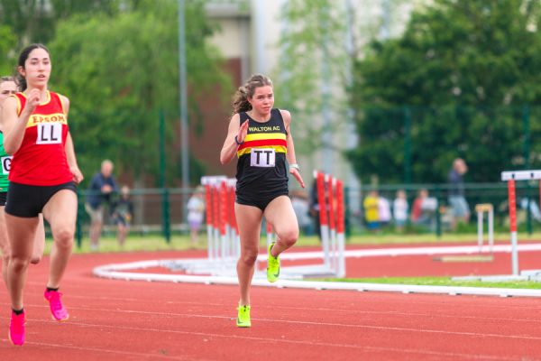 Woman running on an athletics track