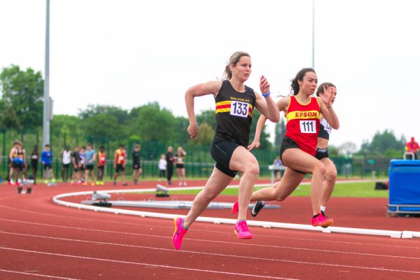 Women running on an athletics track