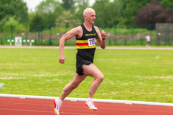 Man running on an athletic track
