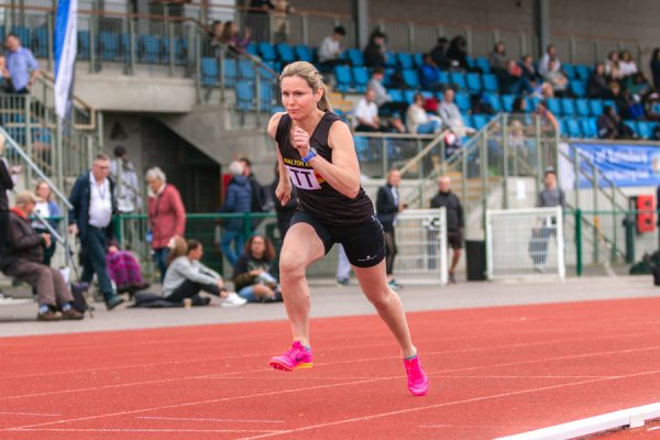 Woman running on an athletic track