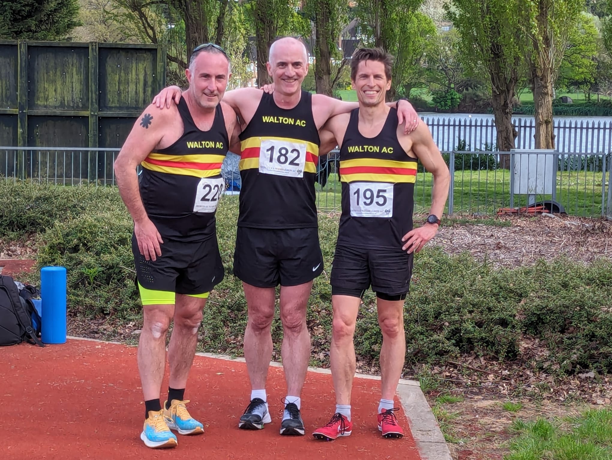 Three men in Walton ac running vests
