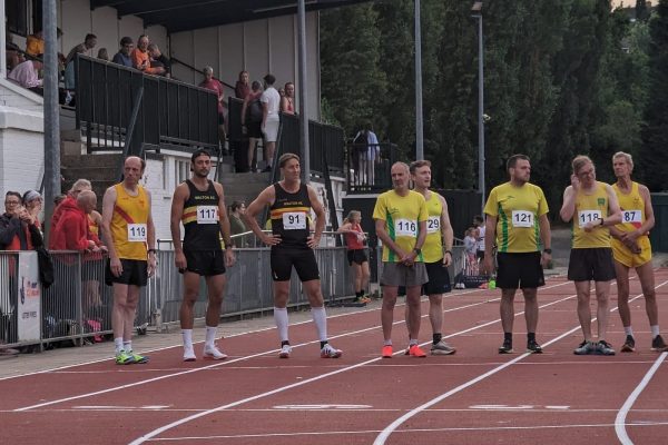 Men on the start line of an athletics track