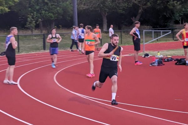 Man running on an athletics track