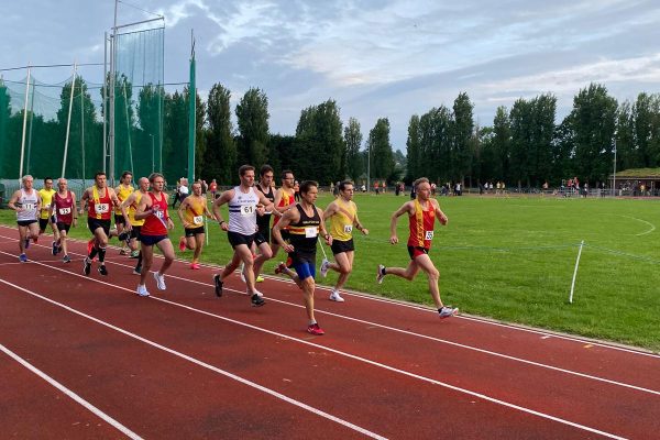 Group of athletes running on an athletics track