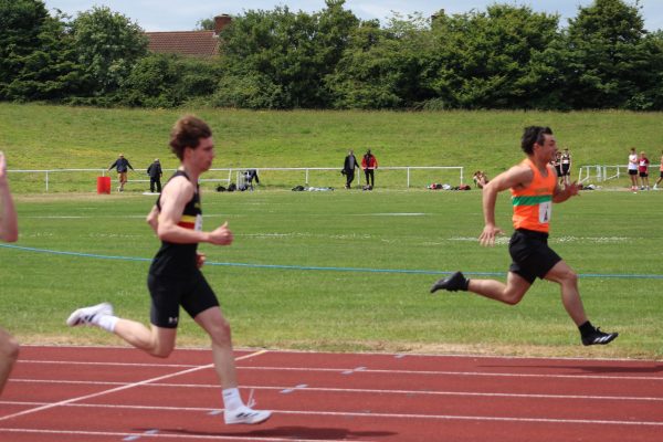 Boy in Walton vest on athletics track